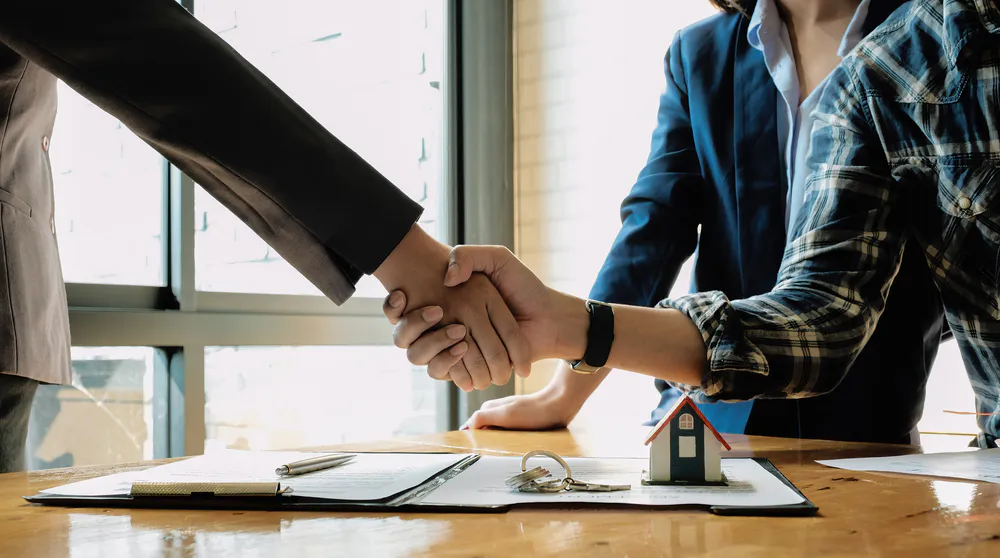 real estate agent and customers shaking hands toge 2025 01 10 07 10 07 utc